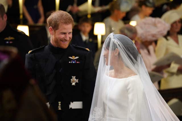 Prince Harry looks at his bride as she arrives (Jonathan Brady/PA)