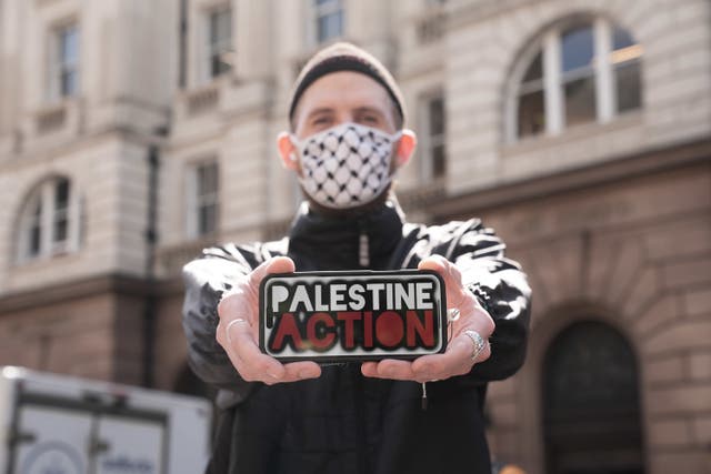 A Palestine Action protester outside the Royal Courts of Justice on The Strand, central London