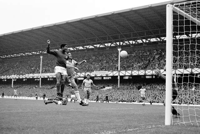 Portugal’s Eusebio scores against Brazil at Goodison Park during the 1966 World Cup group stage (PA)
