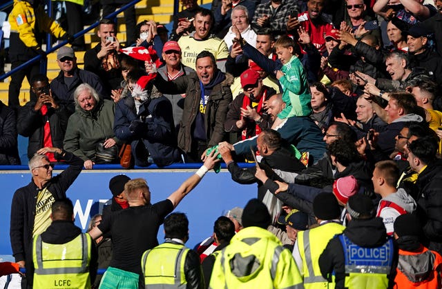 Aaron Ramsdale hands his shirt to a young fan