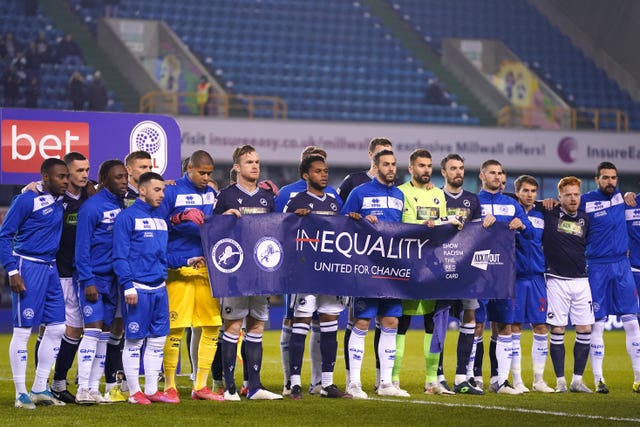 The crowd responded with applause as the two sets of players stood together with a banner promoting racial equality