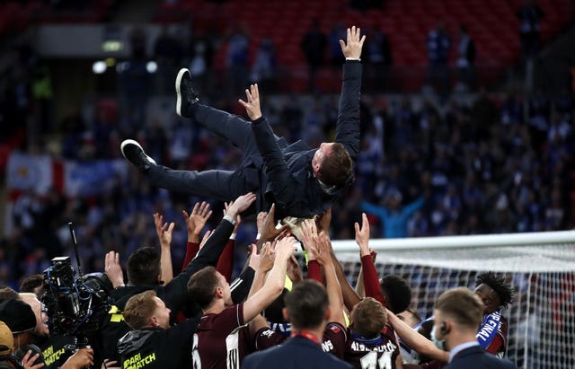 Leicester manager Brendan Rodgers is thrown in the air by his players