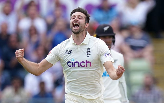 Mark Wood celebrates taking the wicket of Henry Nicholls 