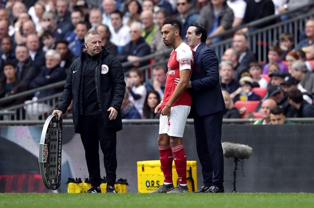 Pierre-Emerick Aubameyang, centre, prepares to come on