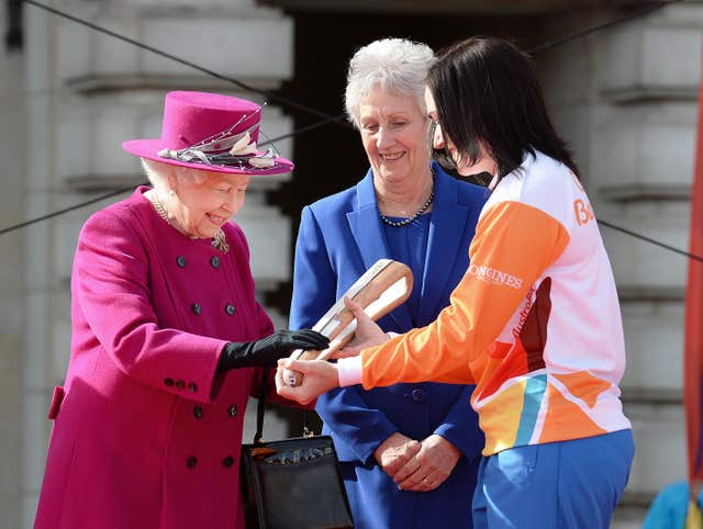 (From the left) The Queen, with Louise Martin, President of the Commonwealth Games Federation, and Anna Mears, the Australian cycling gold medallist, launches the Queen’s Baton Relay for the XXI Commonwealth Games, last year. (John Stillwell/PA)