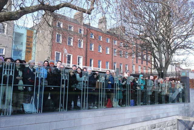 People await the arrival of the Duke and Duchess of Cambridge for their visit to the Garden of Remembrance in Dublin