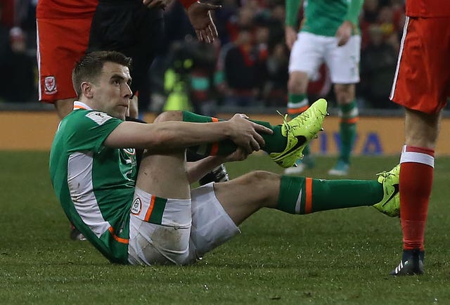 Republic of Ireland skipper Seamus Coleman holds his broken leg after a challenge from Wales’ Neil Taylor in March 2017