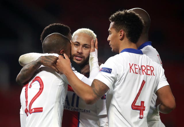 Paris Saint Germain's Neymar celebrates with his team-mates after scoring the third goal at at Old Trafford