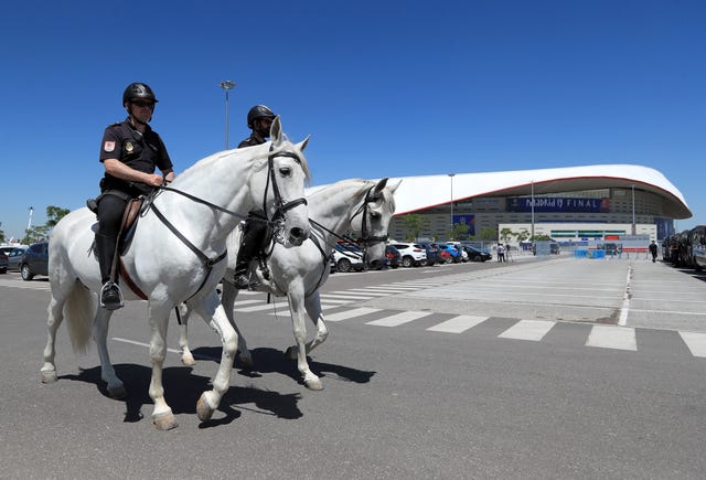 Police on horseback patrol outside the Wanda Metropolitano stadium in Madrid
