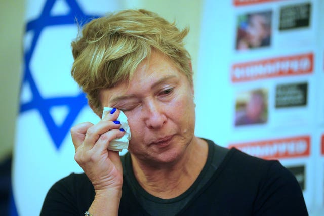 Iris Haim, the mother of Israeli hostage Yotam Haim currently being held in Gaza, wipes her eye during a press conference at the Israel embassy in London