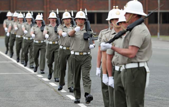 Members of the Royal Marines march across the parade ground at HMS Collingwood (Andrew Matthews/PA)