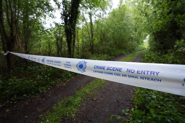Police tape at a forested site