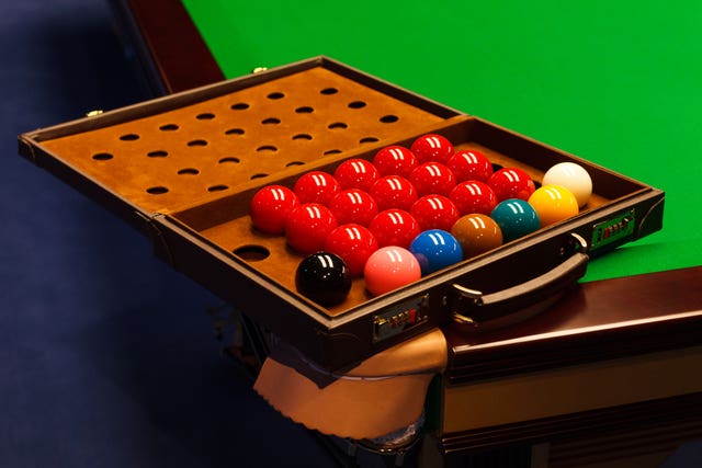 Snooker balls are lined up in a suitcase (PA)