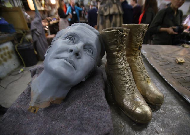 A 3D-printed head – used as a starting point to model the finished head of the statue – alongside a pair of boots that were fitted to an unfinished statue of suffragist leader Millicent Fawcett (Yui Mok/PA)