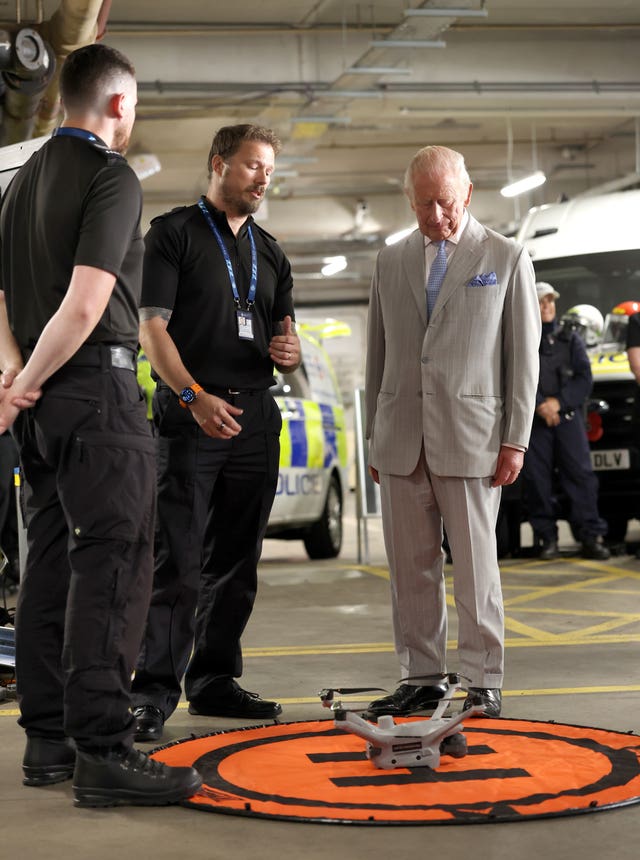 The King speaks with specialist officers from the drone team as he officially opens the headquarters of the British Transport Police in central London