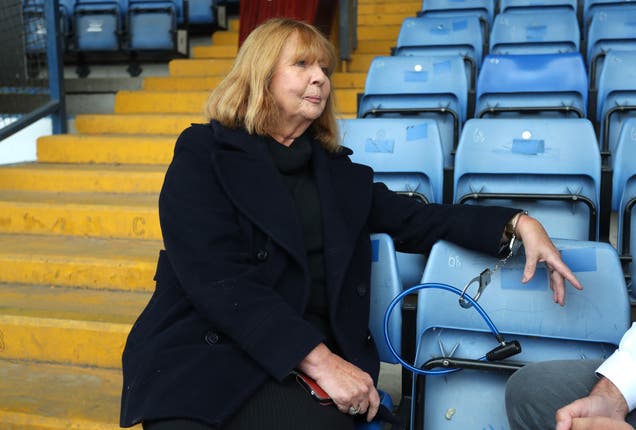 Former director Joy Hart handcuffs herself to a seat inside Gigg Lane