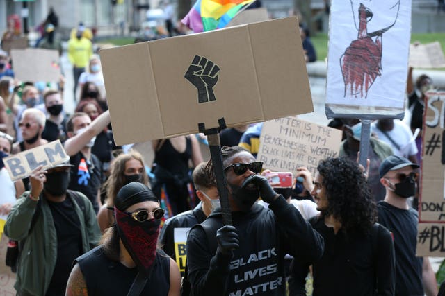 People during a Black Lives Matter rally walk along Victoria Street in London