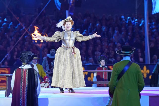 Dame Helen Mirren dressed as Queen Elizabeth I performs