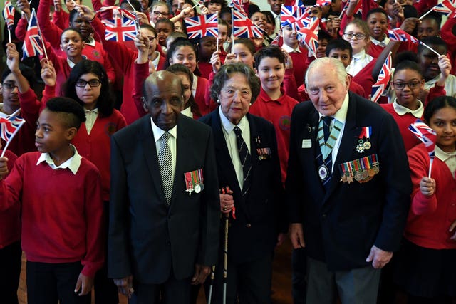 Veterans Mervyn Kerch, 95, Marzena Schejbal, 95, and Neil Flanigan, 96, with pupils at Sandhurst Primary School in south east London (Kirsty O'Connor/PA)