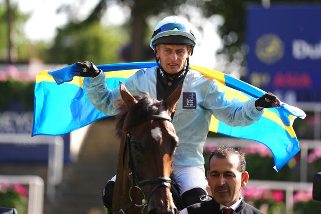 Team Europe jockey Per-Anders Graberg celebrates after winning on Ebt's Guard