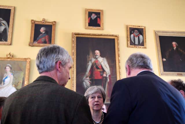 Theresa May speaks to local officials and members of the emergency services as she visits Salisbury to view the area of the suspected nerve agent attack ( Toby Melville/PA)