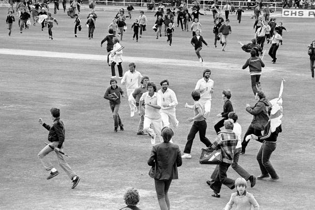 Willis (centre) leading the side off after England's sensational victory over Australia in the Third Cornhill Test of The Ashes at Headingley as fans run on to celebrate