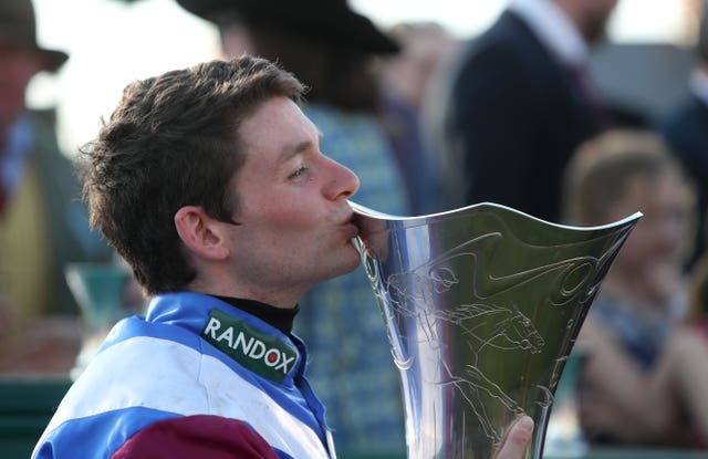 Derek Fox kisses the trophy after winning the 2017 Grand National aboard One For Arthur
