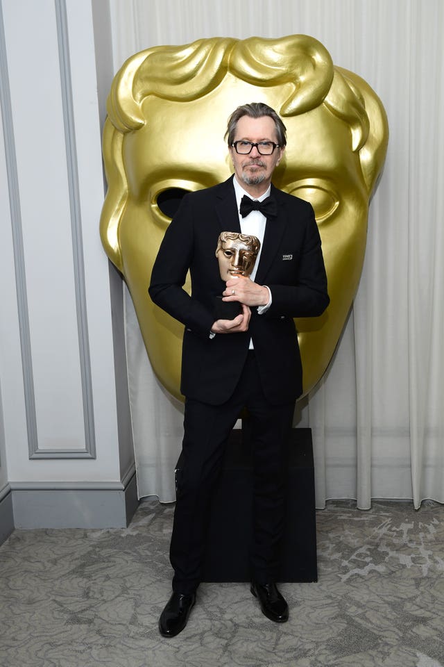 Gary Oldman with his Bafta for his portrayal of Winston Churchill in Darkest Hour (Ian West/PA)