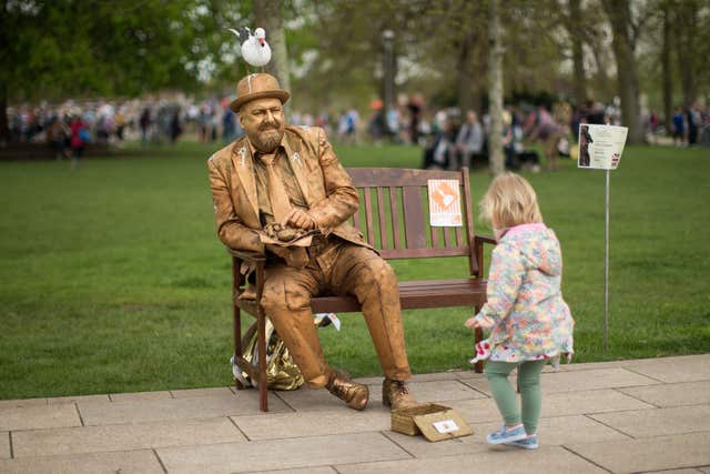 Another admirer of The Goldman during the National Living Statue Competition (Aaron Chown/PA) 