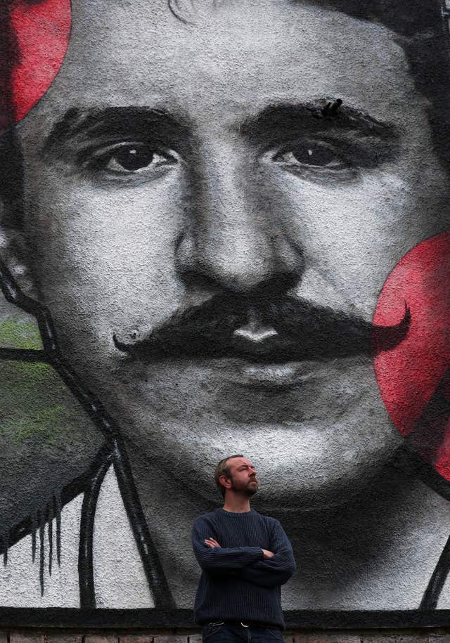 Artist Bobby McNamara known as Rogue-one views his mural dedicated to Charles Rennie Mackintosh (Andrew Milligan/PA)