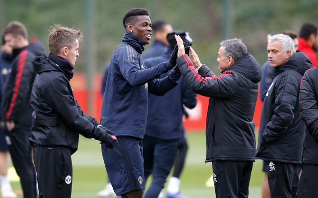 Paul Pogba (centre) high-fives assistant coach Ricardo Formosino (second right) ahead of his return to Turin