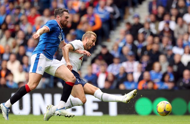 Harry Kane, right, shoots against Rangers