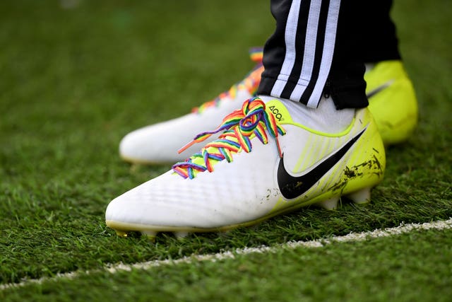 A pair of football boots with rainbow laces