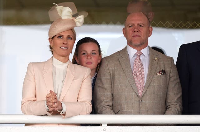 Zara and Mike Tindall and their daughter Mia in the grandstand watching the Debenhams Handicap Hurdle on day two of the Randox Grand National Festival 2026 at Aintree Racecourse.