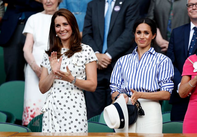 The Duchess of Cambridge and the Duchess of Sussex in the royal box on centre court after the Ladies Singles final on day twelve of the Wimbledon Championships at the All England Lawn Tennis and Croquet Club, Wimbledon.