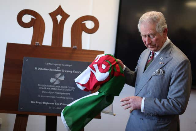 The Prince of Wales unveils a commemorative plaque at the base in Dafen (Aaron Chown/PA)