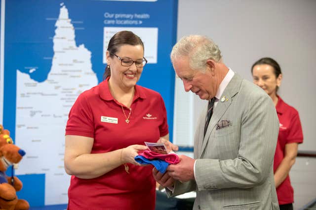 Charles is given a gift at the Royal Flying Doctors Service base in Cairns (Steve Parsons/PA)