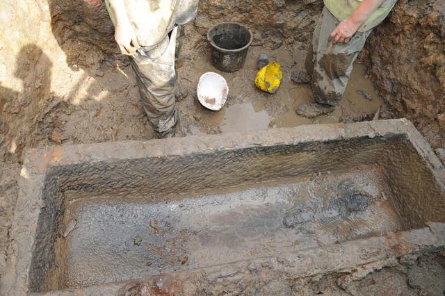 A lid of a sarcophagus uncovered in one of the tombs (PA)