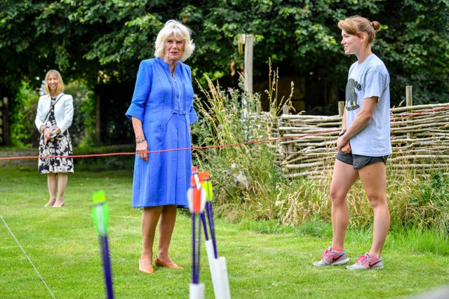 The Duchess of Cornwall chats with archery instructor Emily Daubmey during a visit to the Youth Action Wiltshire Oxenwood Outdoor Activity Centre near Marlborough, Wiltshire