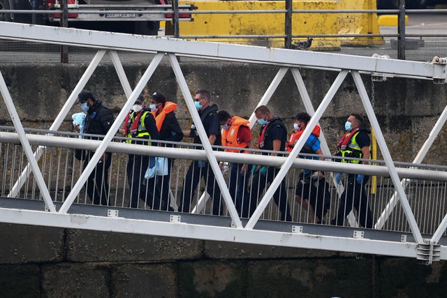 A group of people, thought to be migrants, disembarking