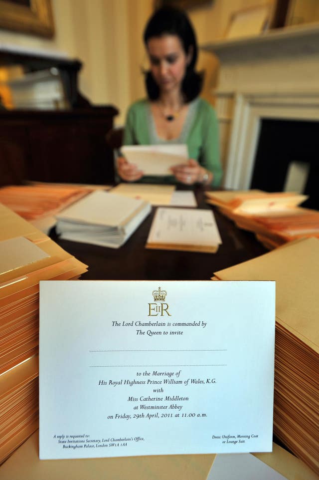 A member of the Lord Chamberlain's Office inserts the invitations into envelopes for William and Kate's wedding in 2011 (John Stillwell/PA)