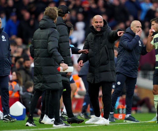 Manchester City manager Pep Guardiola speaks with Liverpool boss Jurgen Klopp