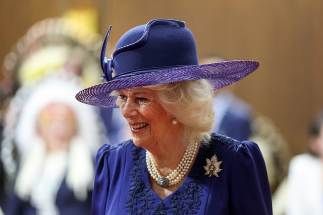 Camilla in a violet hat