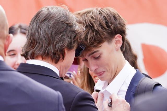 Tom Cruise signing a shirt for a fan at the Digger royal performance