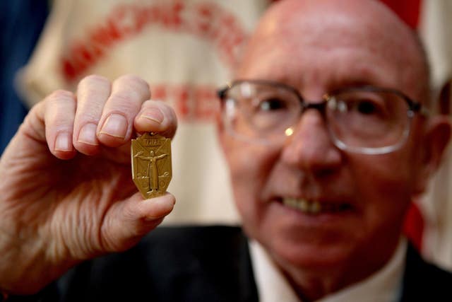 Stiles holding his 1966 World Cup winner's medal