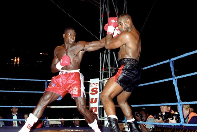 Frank Bruno throws a left to the head of Oliver McCall at Wembley Stadium