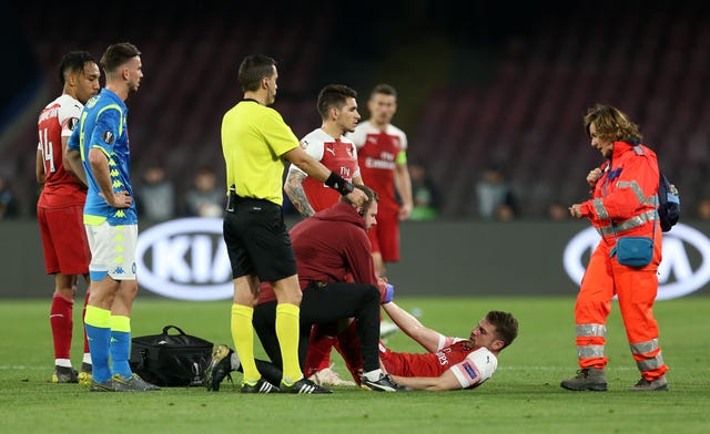 Aaron Ramsey receives treatment after picking up an injury