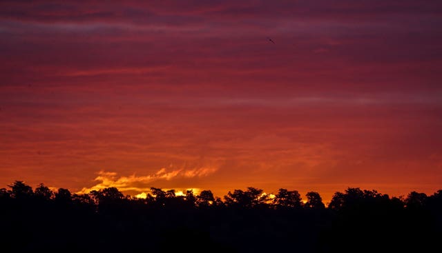 The sun rises over fields near Cookham, Berkshire