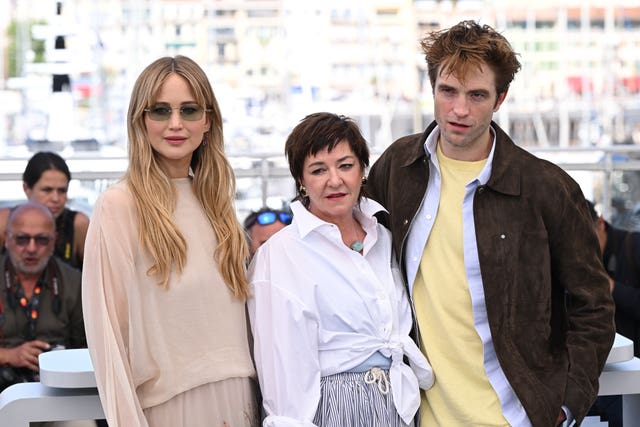 Jennifer Lawrence and Robert Pattinson with director Lynne Ramsay at a photocall for Die My Love during the Cannes Film Festival