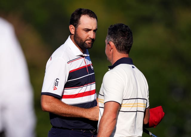 Scottie Scheffler, left, shakes Rory McIlroy's hand